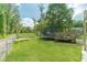 Spacious backyard featuring a trampoline, wooden deck and lush green grass, perfect for outdoor activities at 1623 Pratt Rd, Covington, GA 30014