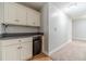 Basement nook features built-in cabinets and drawers, neutral paint, and carpeted flooring at 1623 Pratt Rd, Covington, GA 30014