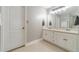 Bright bathroom featuring a double vanity, large mirror, and neutral decor at 1623 Pratt Rd, Covington, GA 30014