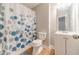 Bathroom with vinyl flooring features a shower, vanity, and toilet with blue accents at 1623 Pratt Rd, Covington, GA 30014
