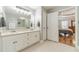 Bright bathroom featuring double vanity, large mirror, and ensuite access at 1623 Pratt Rd, Covington, GA 30014
