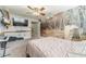 Bedroom featuring a decorative wall, ceiling fan and mounted TV for entertainment at 1623 Pratt Rd, Covington, GA 30014