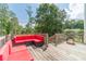 Outdoor deck with a red outdoor furniture set and a great backyard view at 1623 Pratt Rd, Covington, GA 30014