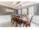 Spacious dining room with modern light fixture, large wood table, and decorative wall trim at 1623 Pratt Rd, Covington, GA 30014