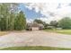 Side view of a home featuring an attached two-car garage and a long concrete driveway at 1623 Pratt Rd, Covington, GA 30014