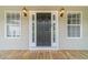 Inviting front door with sidelights and decorative sconces, enhancing the home's curb appeal at 1623 Pratt Rd, Covington, GA 30014