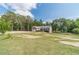 Charming single-story home with well-manicured lawn, mature trees, and brick exterior at 1623 Pratt Rd, Covington, GA 30014