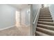 Hallway area features carpeted stairs and a bathroom with white paneled doors at 1623 Pratt Rd, Covington, GA 30014
