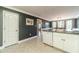 Kitchen featuring stainless steel appliances, granite countertops, white cabinetry, plus access to dining room at 1623 Pratt Rd, Covington, GA 30014