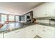 Kitchen with granite countertops, stainless appliances, white cabinetry, and overhead lighting at 1623 Pratt Rd, Covington, GA 30014