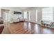 Bright living room featuring hardwood floors, a front entry door, plus large windows at 1623 Pratt Rd, Covington, GA 30014
