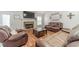 Inviting living room with a brick fireplace, a mounted TV, and cozy seating arrangements for relaxation at 1623 Pratt Rd, Covington, GA 30014