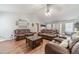 Open-concept living area featuring a vaulted ceiling, modern lighting, and stylish leather furniture at 1623 Pratt Rd, Covington, GA 30014