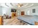 Spacious main bedroom featuring tray ceiling, wood floors, sitting area, and ensuite access at 1623 Pratt Rd, Covington, GA 30014