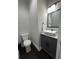 Chic half-bathroom featuring a modern vessel sink and custom gray cabinets at 2668 Memorial Se Dr, Atlanta, GA 30317
