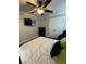 Cozy bedroom with ceiling fan, mounted TV, and a neutral color palette at 2668 Memorial Se Dr, Atlanta, GA 30317