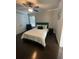 Bright bedroom with a ceiling fan, dark wood floors, and ensuite bathroom at 2668 Memorial Se Dr, Atlanta, GA 30317