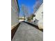 Wide concrete driveway leading to a detached garage, flanked by well-maintained landscaping at 2668 Memorial Se Dr, Atlanta, GA 30317