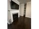 Elegant fireplace with white mantle, gray tile surround, and built-in shelving at 2668 Memorial Se Dr, Atlanta, GA 30317