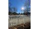 Charming view of the front yard and street beyond a classic white picket fence at 2668 Memorial Se Dr, Atlanta, GA 30317