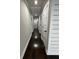Long hallway featuring neutral walls, wooden floors, and multiple doors at 2668 Memorial Se Dr, Atlanta, GA 30317