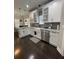 Bright kitchen features white cabinets, stainless appliances, and modern pendant lights at 2668 Memorial Se Dr, Atlanta, GA 30317
