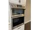 Built-in stainless steel double oven with white cabinets in a modern kitchen at 2668 Memorial Se Dr, Atlanta, GA 30317