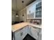 Bright kitchen with white cabinets, granite countertops, and modern pendant lighting at 2668 Memorial Se Dr, Atlanta, GA 30317