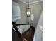 Bright stairway featuring dark wood steps, white railing, and modern light fixture at 2668 Memorial Se Dr, Atlanta, GA 30317