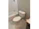 Modern toilet with a nearby bathtub and vanity, as well as neutral paint at 2668 Memorial Se Dr, Atlanta, GA 30317