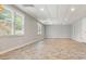 Finished basement with tile floors, recessed lighting, and windows for lots of natural light at 115 Windover Ct, Roswell, GA 30075