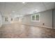 Large basement featuring neutral color paint, tile flooring, and natural light from the exterior at 115 Windover Ct, Roswell, GA 30075