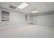 Spacious bedroom with neutral walls and carpet, large windows, and a door at 115 Windover Ct, Roswell, GA 30075