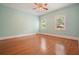 Empty bedroom featuring hardwood floors, two windows, and fresh paint at 115 Windover Ct, Roswell, GA 30075