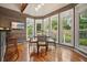 Bright dining area with wood paneling, large windows offering an abundance of natural light and hardwood floors at 115 Windover Ct, Roswell, GA 30075