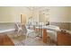 Dining room with modern chandelier, geometric carpet, and white accent chairs at 115 Windover Ct, Roswell, GA 30075