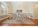 Well-lit dining room with a glass table, an area rug, and wainscoting at 115 Windover Ct, Roswell, GA 30075