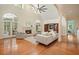 Open-concept living room features hardwood floors, fireplace, and arched windows to the outdoor porch at 115 Windover Ct, Roswell, GA 30075