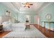 Large main bedroom features trey ceiling, hardwood floors and multiple windows for natural light and outside views at 115 Windover Ct, Roswell, GA 30075