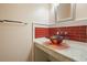 Stylish powder room with modern vanity, a vessel sink, and attractive tile accents at 115 Windover Ct, Roswell, GA 30075