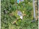 An aerial view of a well-maintained property with a lush landscape, surrounded by mature trees at 25 Highlands Way, Oxford, GA 30054