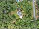 An aerial view of a property address in a lush landscape with mature trees, set on 2.89 acres at 25 Highlands Way, Oxford, GA 30054