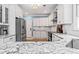 Modern kitchen with white cabinets, granite countertops and stainless steel appliances offers a sleek design at 25 Highlands Way, Oxford, GA 30054