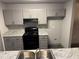 Kitchen with gray cabinets, granite countertops, and a black stove at 3204 Fairington Village Dr, Lithonia, GA 30038