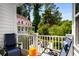 Relaxing balcony features comfortable seating and a view of the surrounding trees and neighborhood at 623 Brennan Dr, Decatur, GA 30033