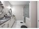 Bathroom featuring double sinks, and a glass-enclosed shower with marble tile at 623 Brennan Dr, Decatur, GA 30033