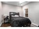 Bedroom featuring a queen-sized bed with a black comforter and a window with blinds at 623 Brennan Dr, Decatur, GA 30033