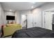 Bright bedroom with a mounted TV, olive loveseat, and closet, offering a cozy retreat at 623 Brennan Dr, Decatur, GA 30033
