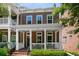 Charming brick townhouse featuring a covered front porch with classic white columns and trim details at 623 Brennan Dr, Decatur, GA 30033