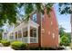 Brick townhome featuring a charming front porch with white pillars, showcasing classic architectural details at 623 Brennan Dr, Decatur, GA 30033